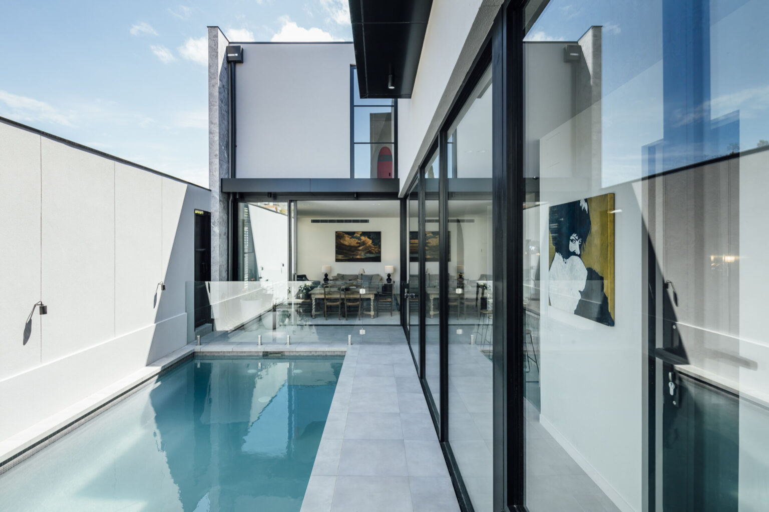 Pool with wrap around sliding ceiling height doors