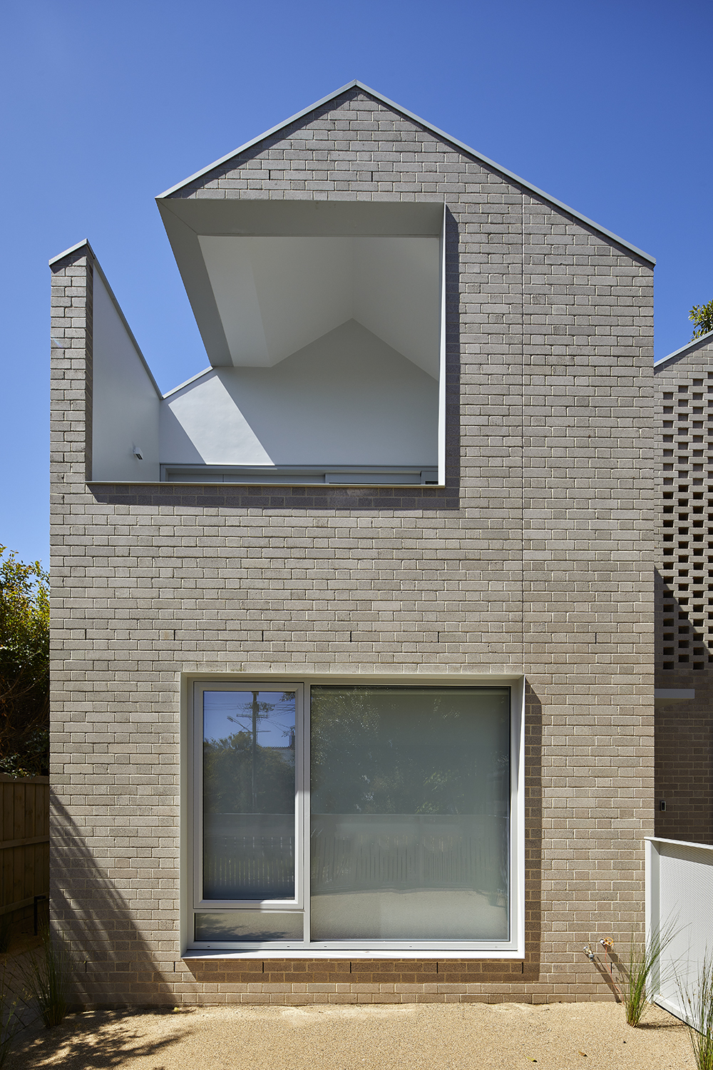 Simple brick townhouse with unique architectural cut out