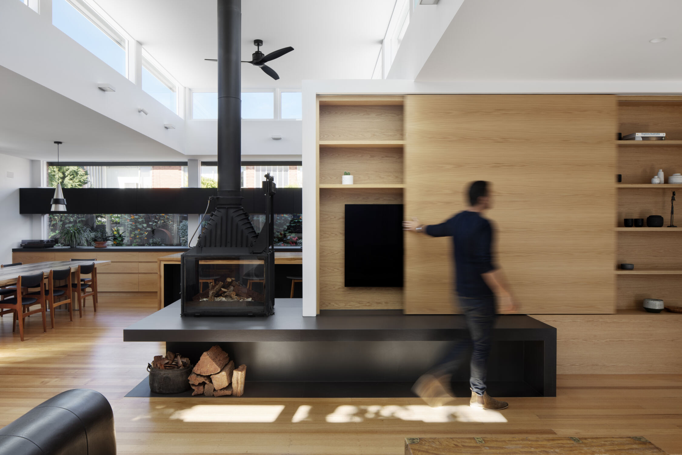 Lounge room with 2 way fire place and custom sliding timber joinery